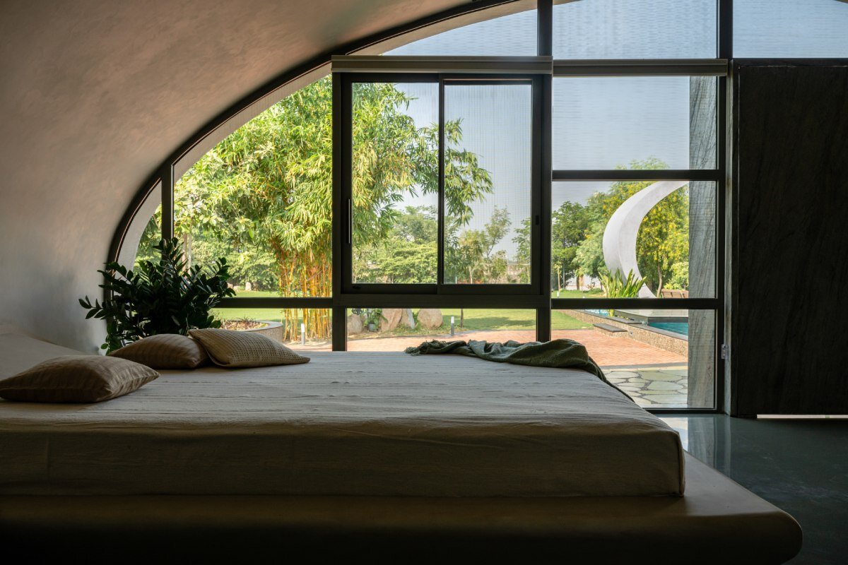 carapace house by achyutam designs carves into tubular concrete volumes in india