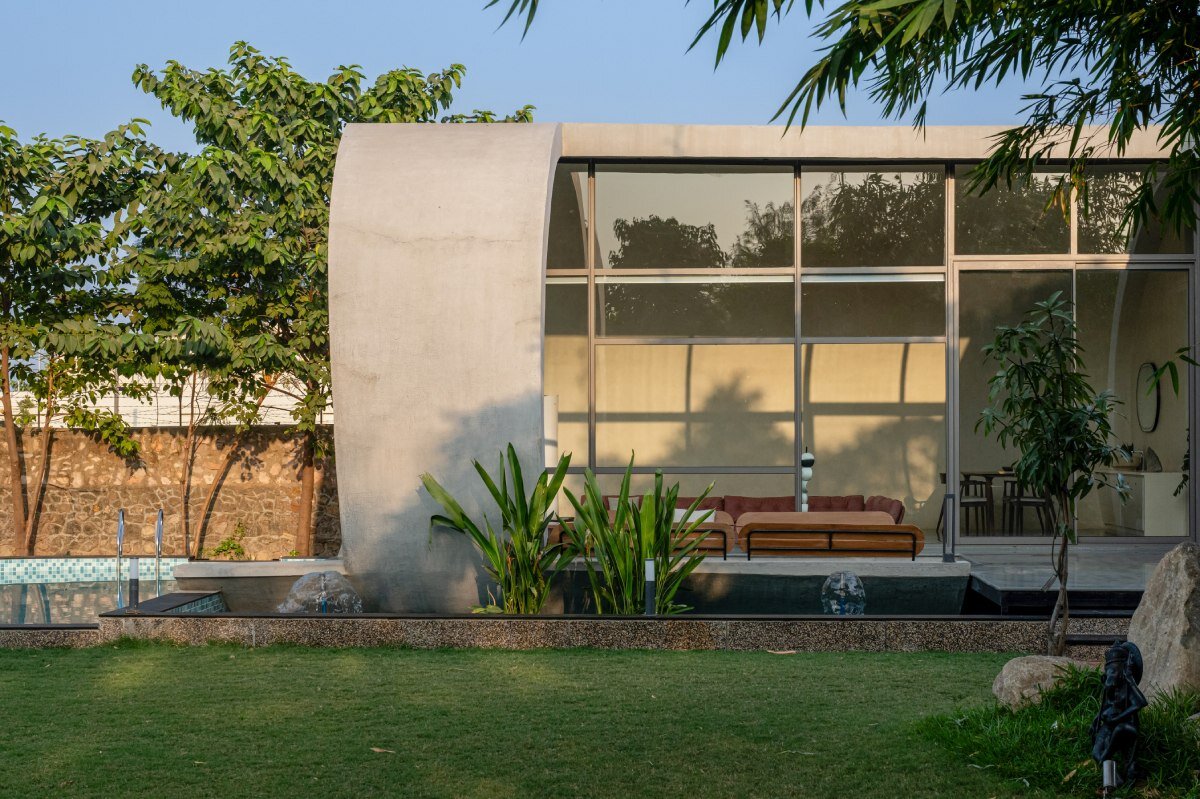 carapace house by achyutam designs carves into tubular concrete volumes in india