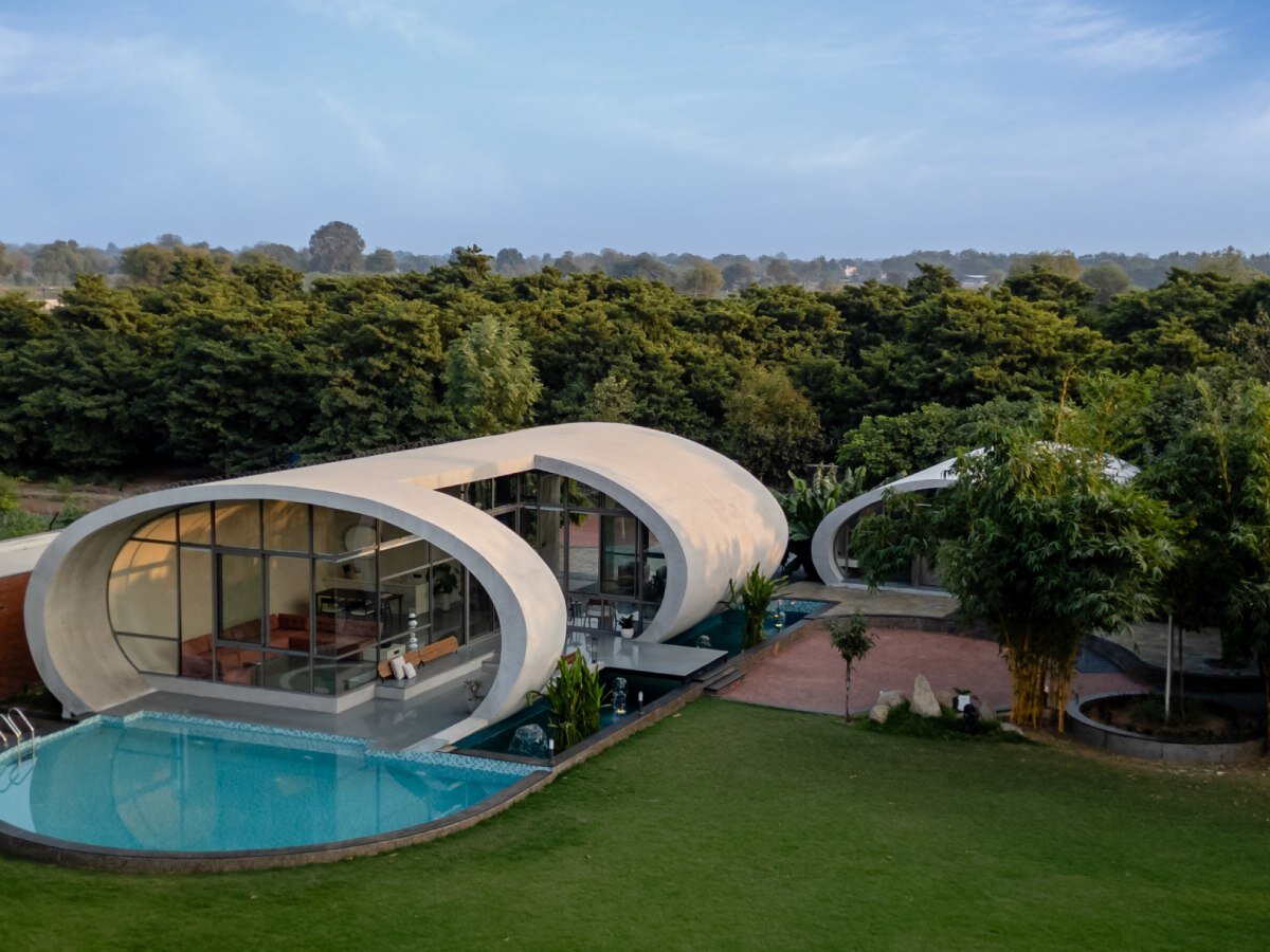 carapace house by achyutam designs carves into tubular concrete volumes in india