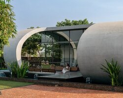 carapace house by achyutam designs carves into tubular concrete volumes in india