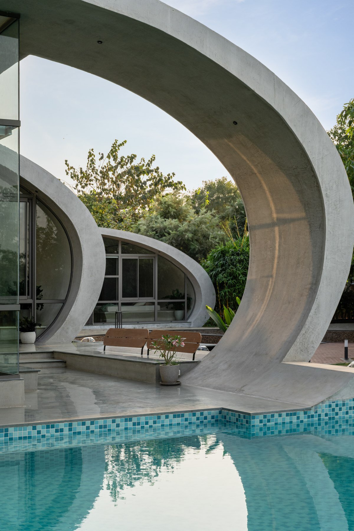 carapace house by achyutam designs carves into tubular concrete volumes in india
