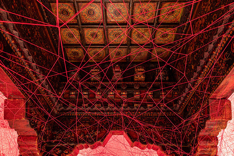 chiharu shiota suspends butterfly wings over warm bed at beijing's red brick art museum