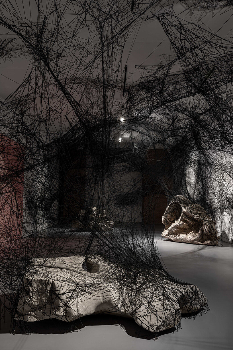 chiharu shiota suspends butterfly wings over warm bed at beijing's red brick art museum