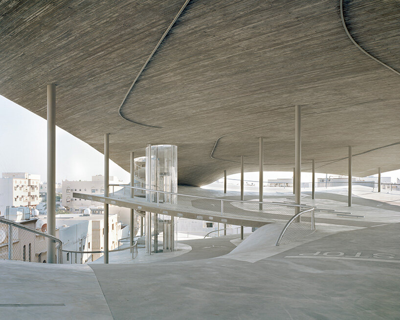 christian kerez eliminates ramps in bahrain car parks with sloping concrete geometries