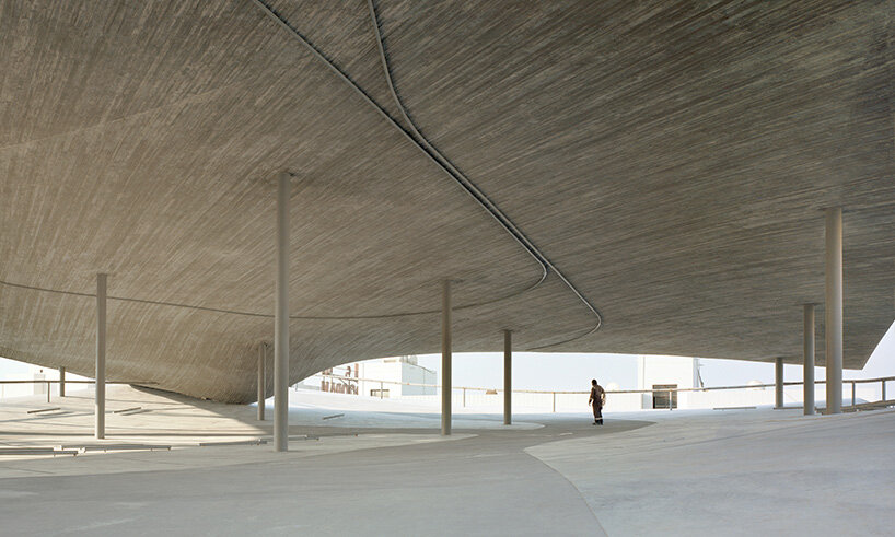 christian kerez eliminates ramps in bahrain car parks with sloping concrete geometries