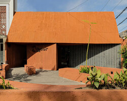 terracotta-tinted concrete district 27 coffee shop reuses old medical laboratory in indonesia