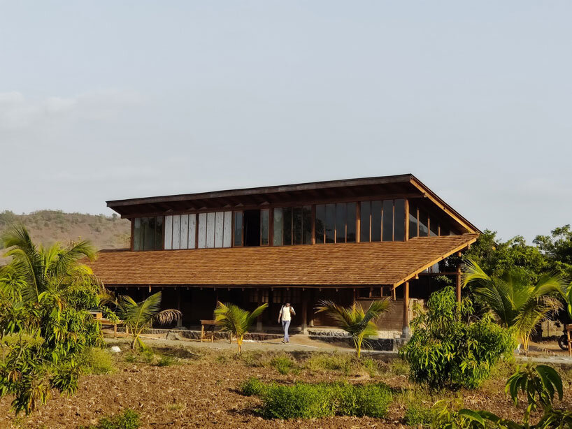 metis practice combines wooden shingles and copper for pali farmhouse's roofing in india