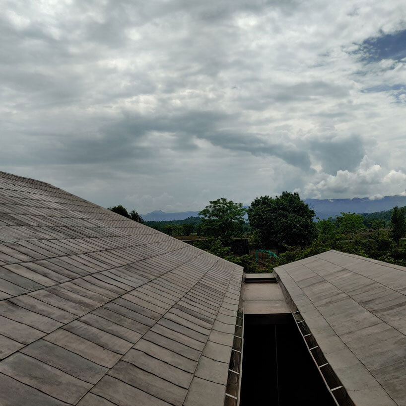 metis practice combines wooden shingles and copper for pali farmhouse's roofing in india