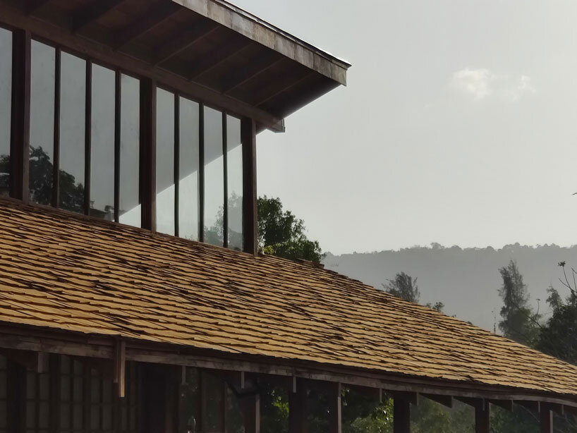 metis practice combines wooden shingles and copper for pali farmhouse's roofing in india