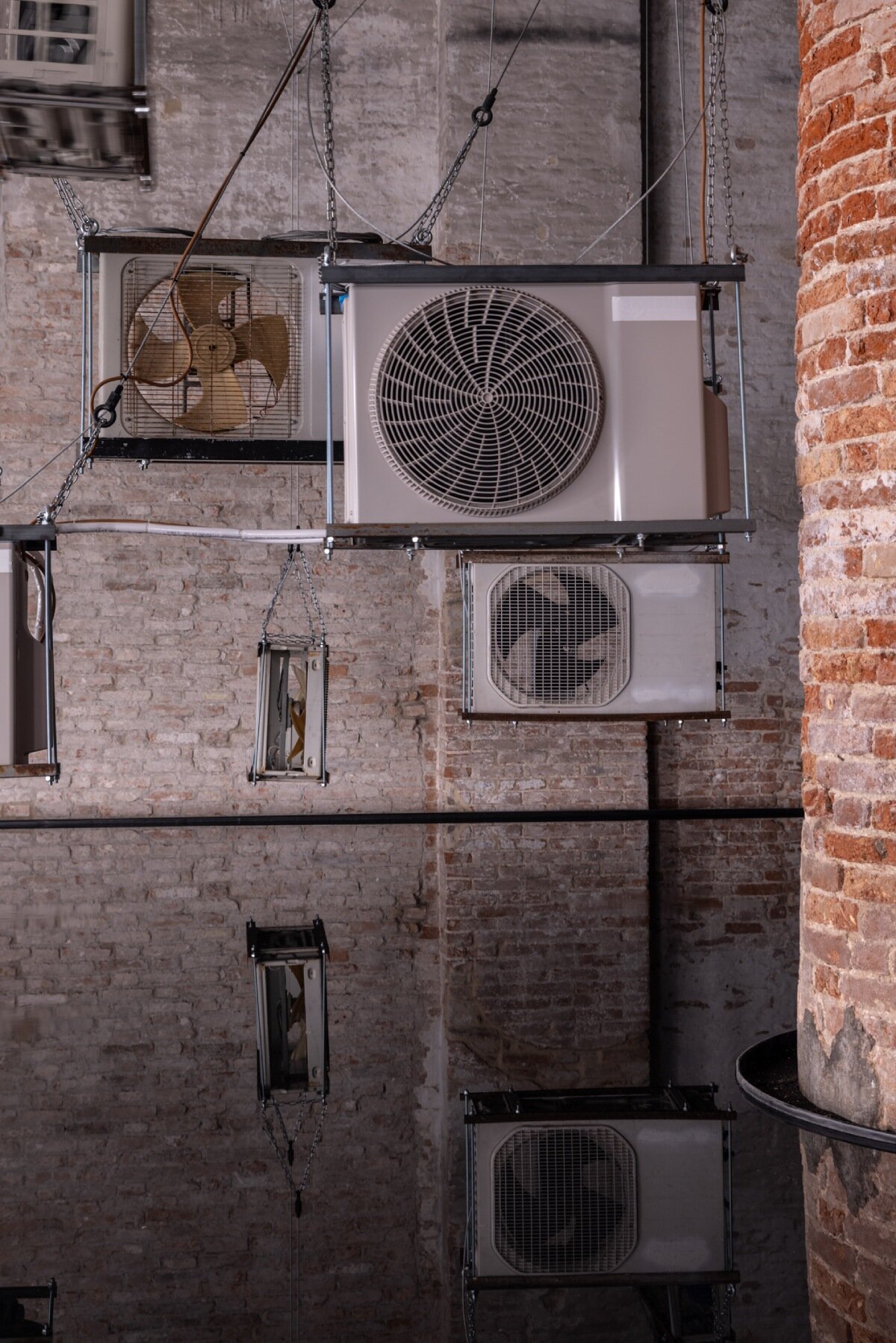 suspended air conditioners & water pools confront global energy impacts at venice biennale