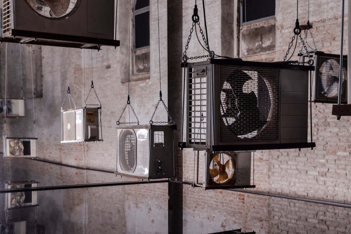suspended air conditioners & water pools confront global energy impacts at venice biennale
