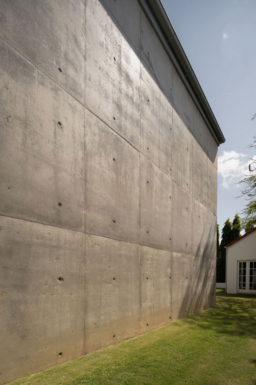 bold concrete frame by george kouparitsas reshapes pre-war cottage's facade in australia