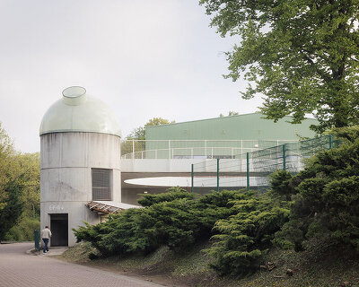 label crowns elevated walkway with telescope-like dome in belgian sports center renovation