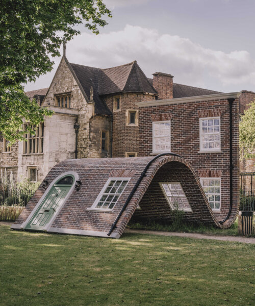 alex chinneck’s monumental brick facade sculpture slides and sits down in a london garden