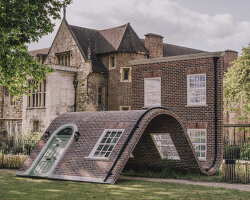 alex chinneck’s monumental brick facade sculpture slides and sits down in a london garden
