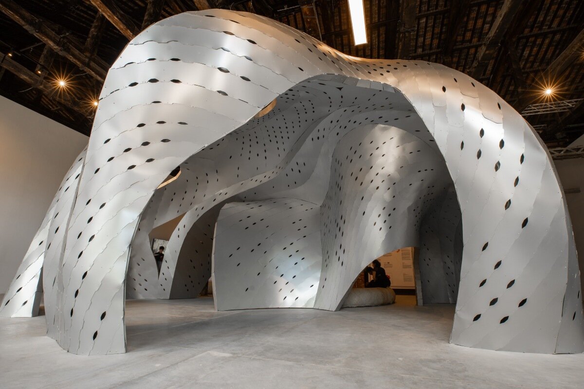 inaugural oman pavilion reimagines traditional gathering spaces as sinuous aluminum shelter