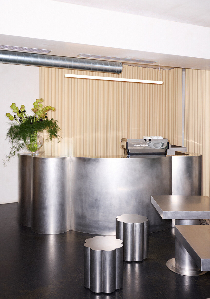 RDZ studio sculpts soft futurism into zurich café with floating cloud bar and tactile interiors