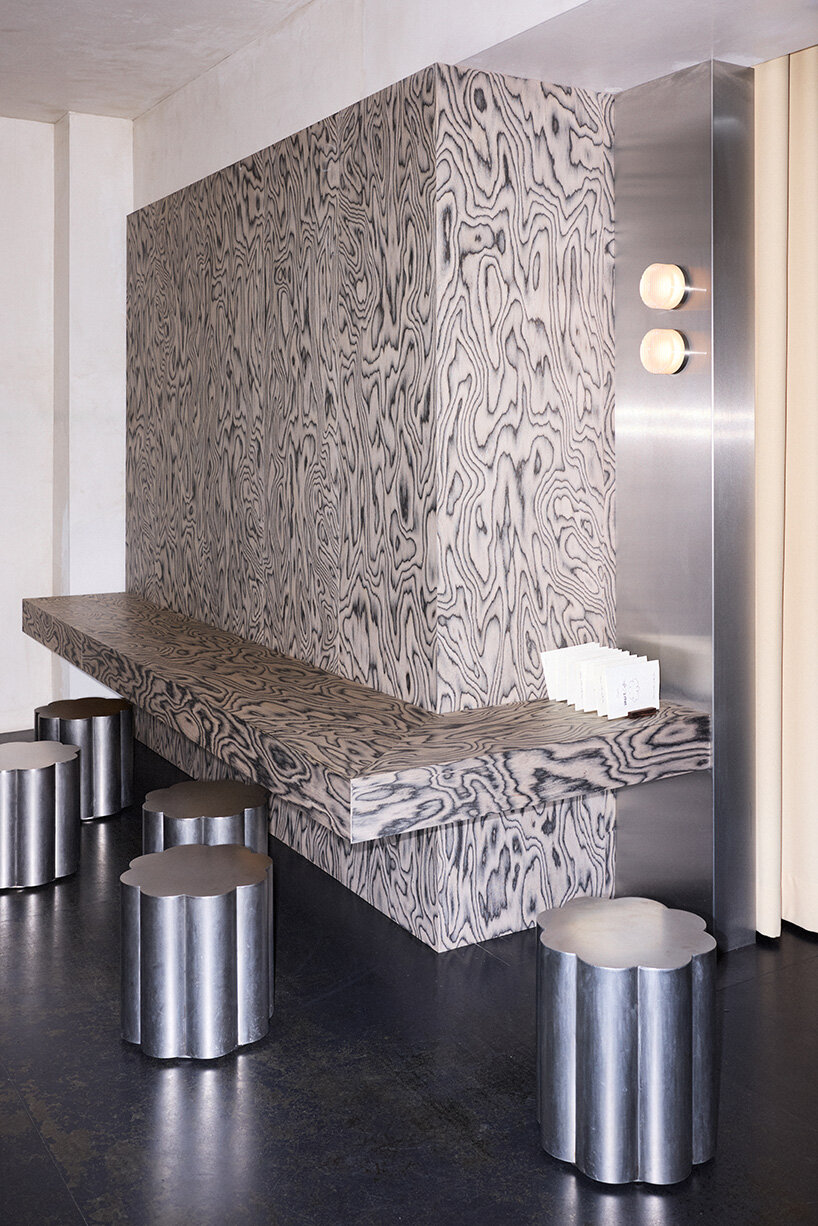 RDZ studio sculpts soft futurism into zurich café with floating cloud bar and tactile interiors