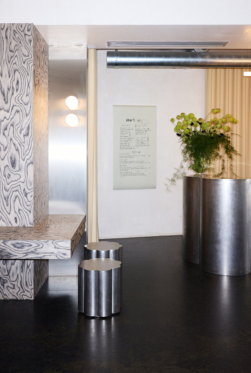 RDZ studio sculpts soft futurism into zurich café with floating cloud bar and tactile interiors