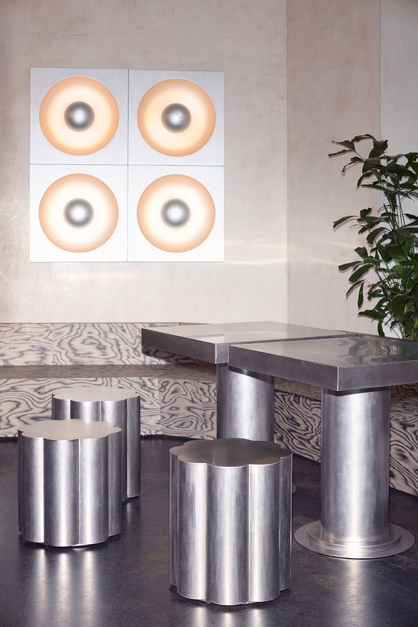 RDZ studio sculpts soft futurism into zurich café with floating cloud bar and tactile interiors