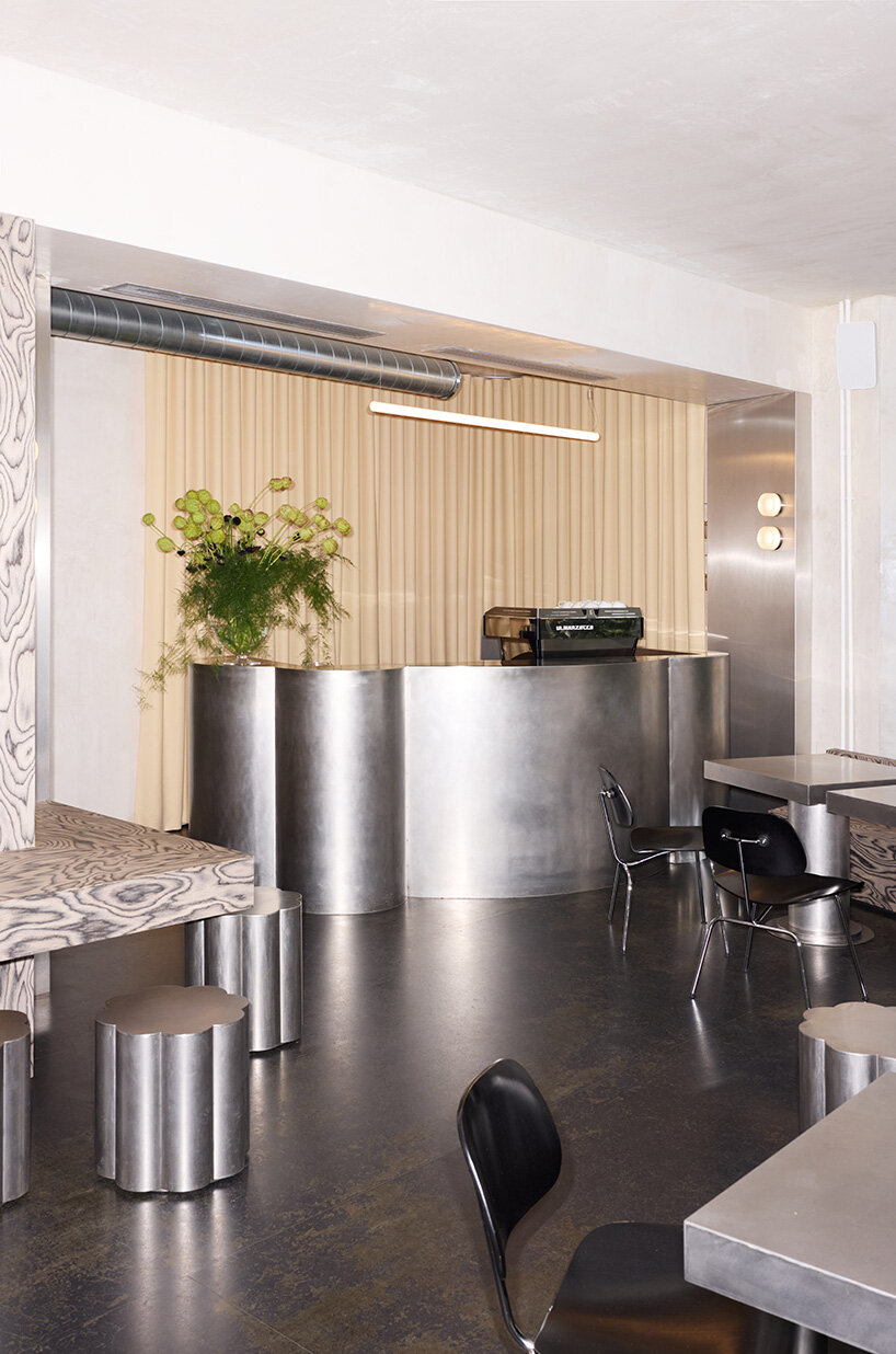 RDZ studio sculpts soft futurism into zurich café with floating cloud bar and tactile interiors