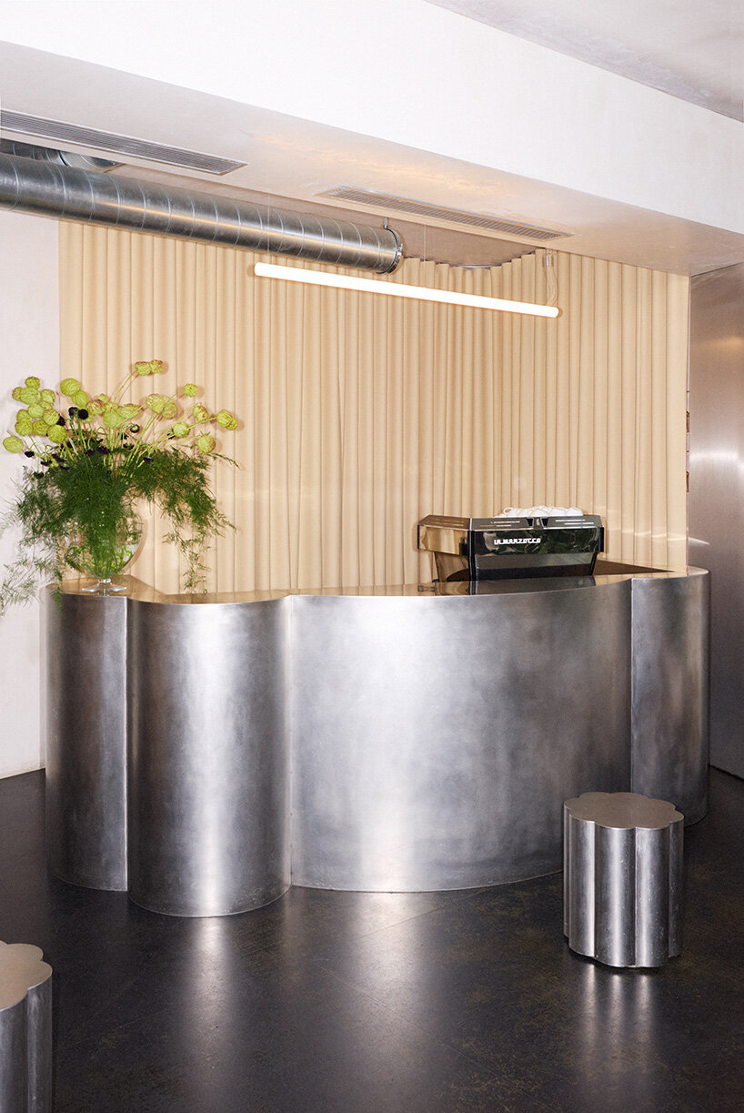 RDZ studio sculpts soft futurism into zurich café with floating cloud bar and tactile interiors