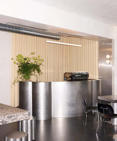 RDZ studio sculpts soft futurism into zurich café with floating cloud bar and tactile interiors