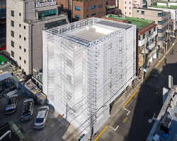 perforated metal panels reframe building's exterior into responsive facade system in seoul