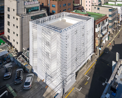perforated metal panels reframe building's exterior into responsive facade system in seoul