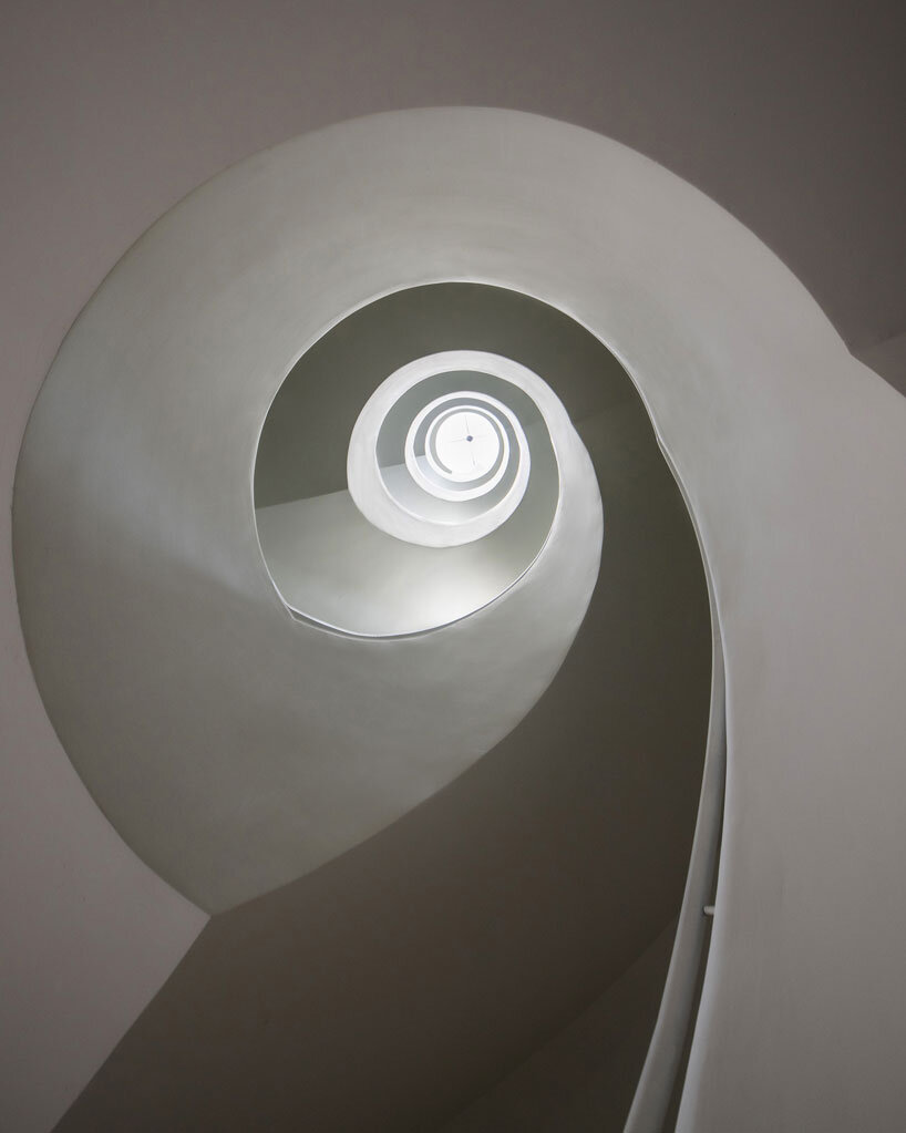 cloud-shaped openings pierce urban co-living unit's concrete facade in vietnam