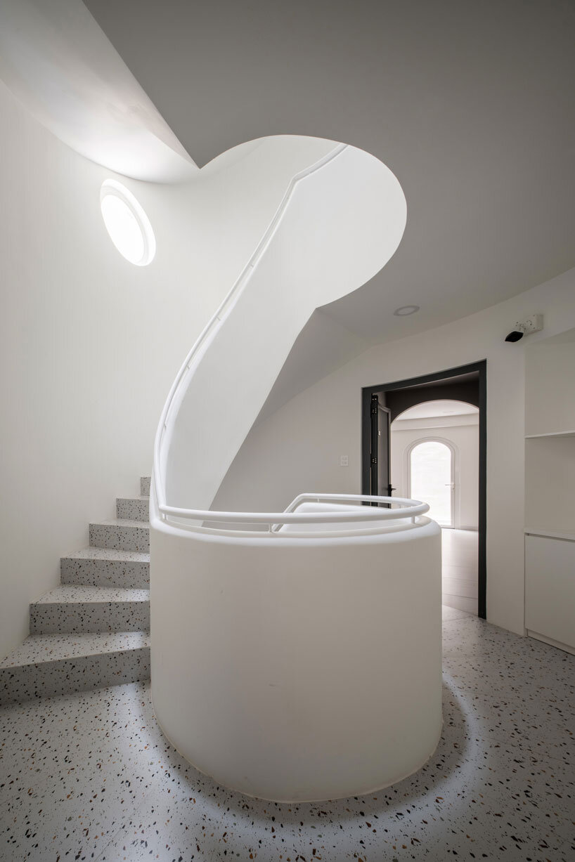 cloud-shaped openings pierce urban co-living unit's concrete facade in vietnam