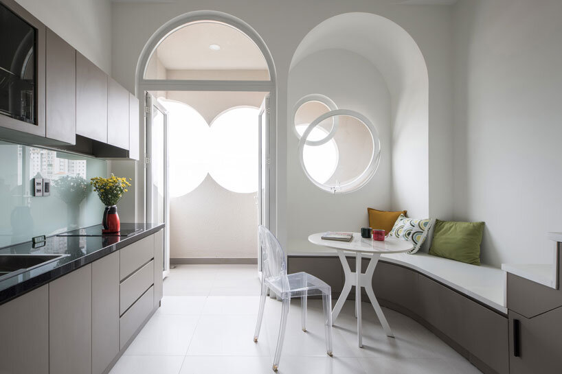 cloud-shaped openings pierce urban co-living unit's concrete facade in vietnam