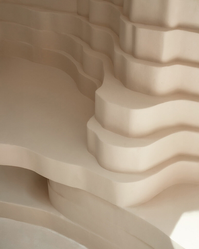 snarkitecture's burger bar takes form in athens with creamy, canyon-like interiors