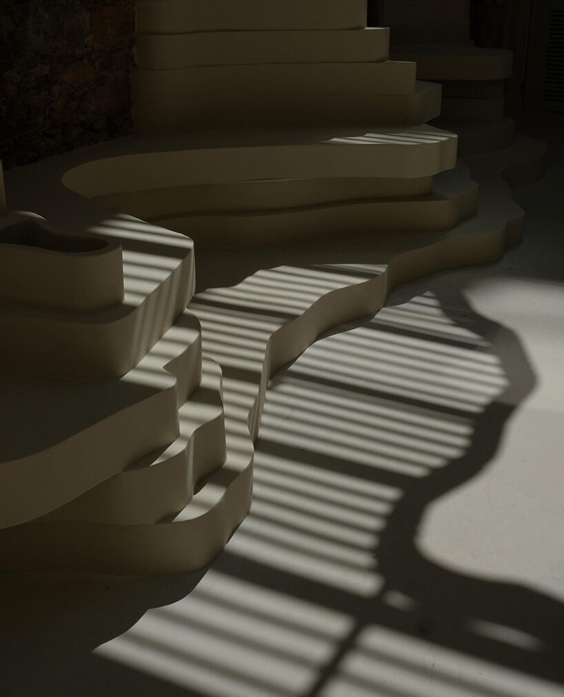 snarkitecture's burger bar takes form in athens with creamy, canyon-like interiors