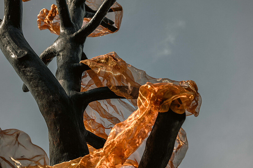 thanos zakopoulos transforms fallen pine into fiery symbol of rebirth at ekies resort in greece