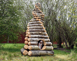 timber twist by ulf mejergren reimagines larvae shelter as spiraling log cabin