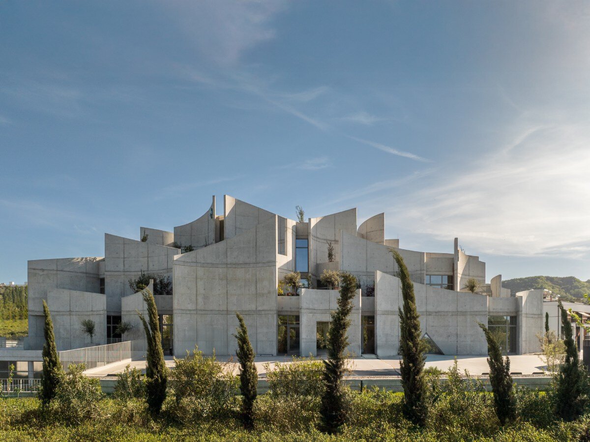 davide macullo's veterinary clinic hides behind a cluster of concrete curves in albania