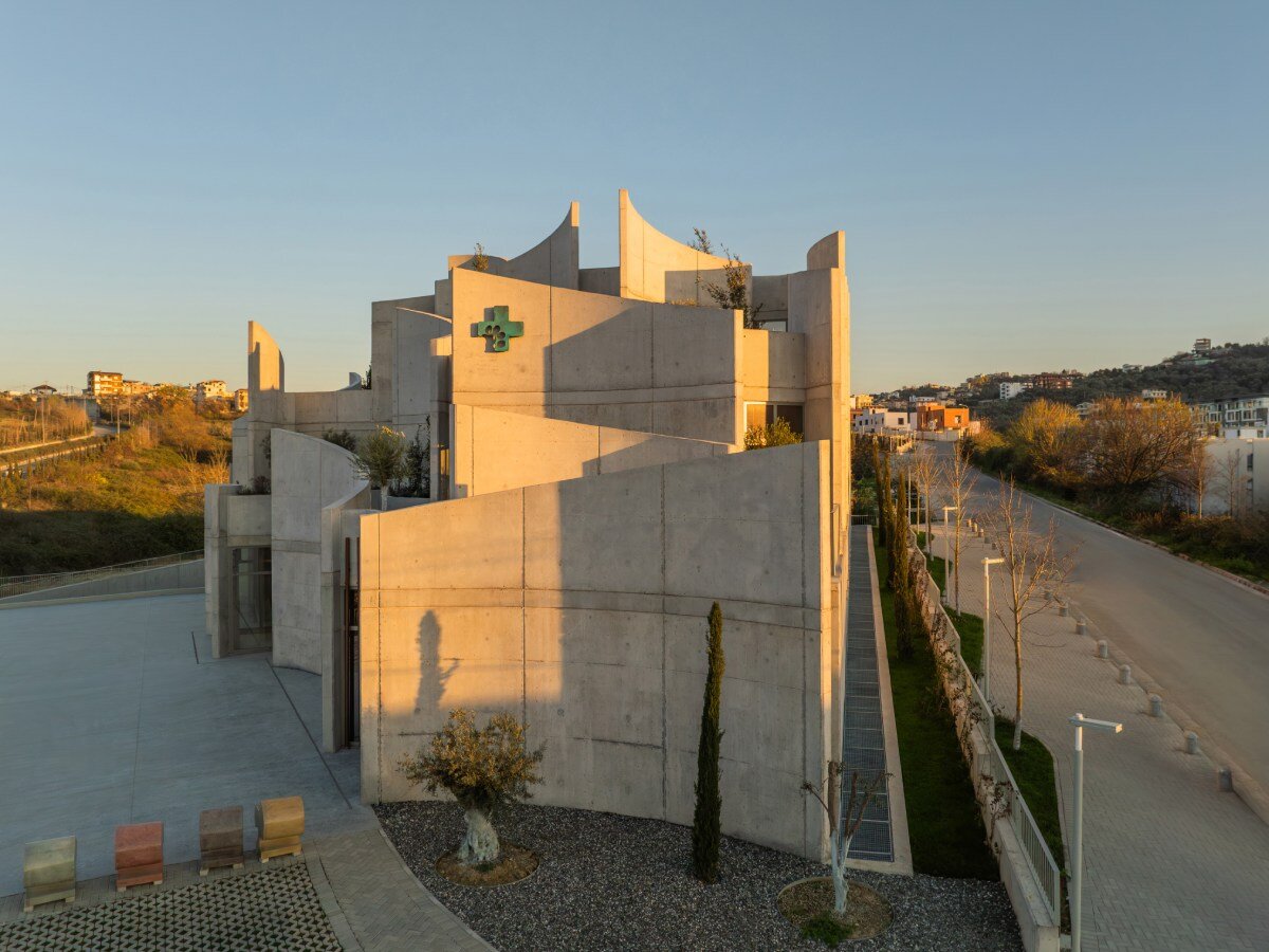 davide macullo's veterinary clinic hides behind a cluster of concrete curves in albania
