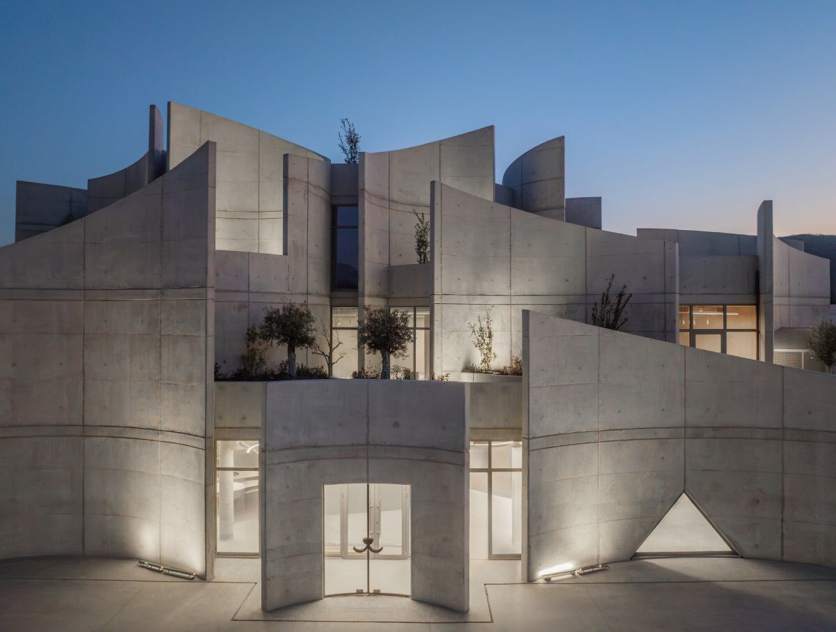 davide macullo's veterinary clinic hides behind a cluster of concrete curves in albania