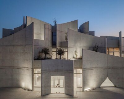 davide macullo's veterinary clinic hides behind a cluster of concrete curves in albania