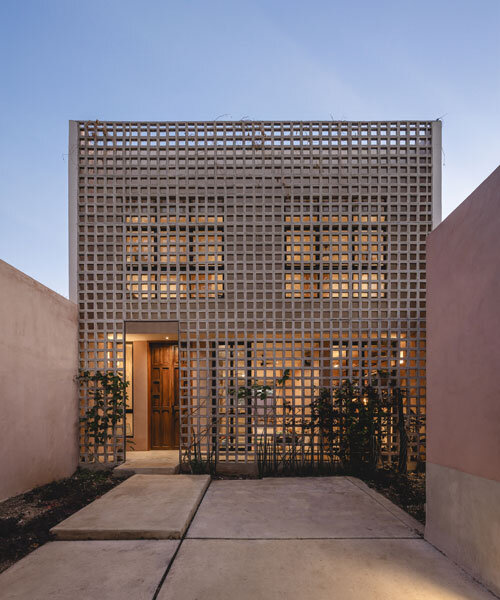 lattice skin encloses casa xcumpich's red volumes by taller mexicano de arquitectura
