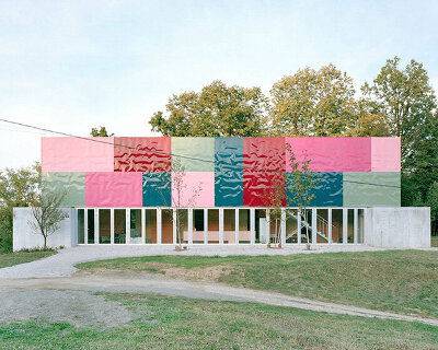 vivid rippled panels envelop TEN's care-based housing for women in bosnia-herzegovina