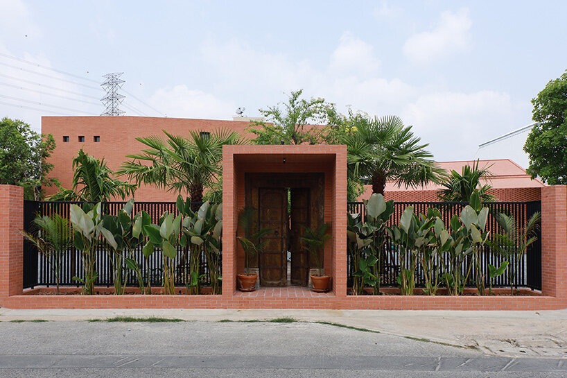 curved brick wall envelops volume matrix studio's multi-functional art space in bangkok