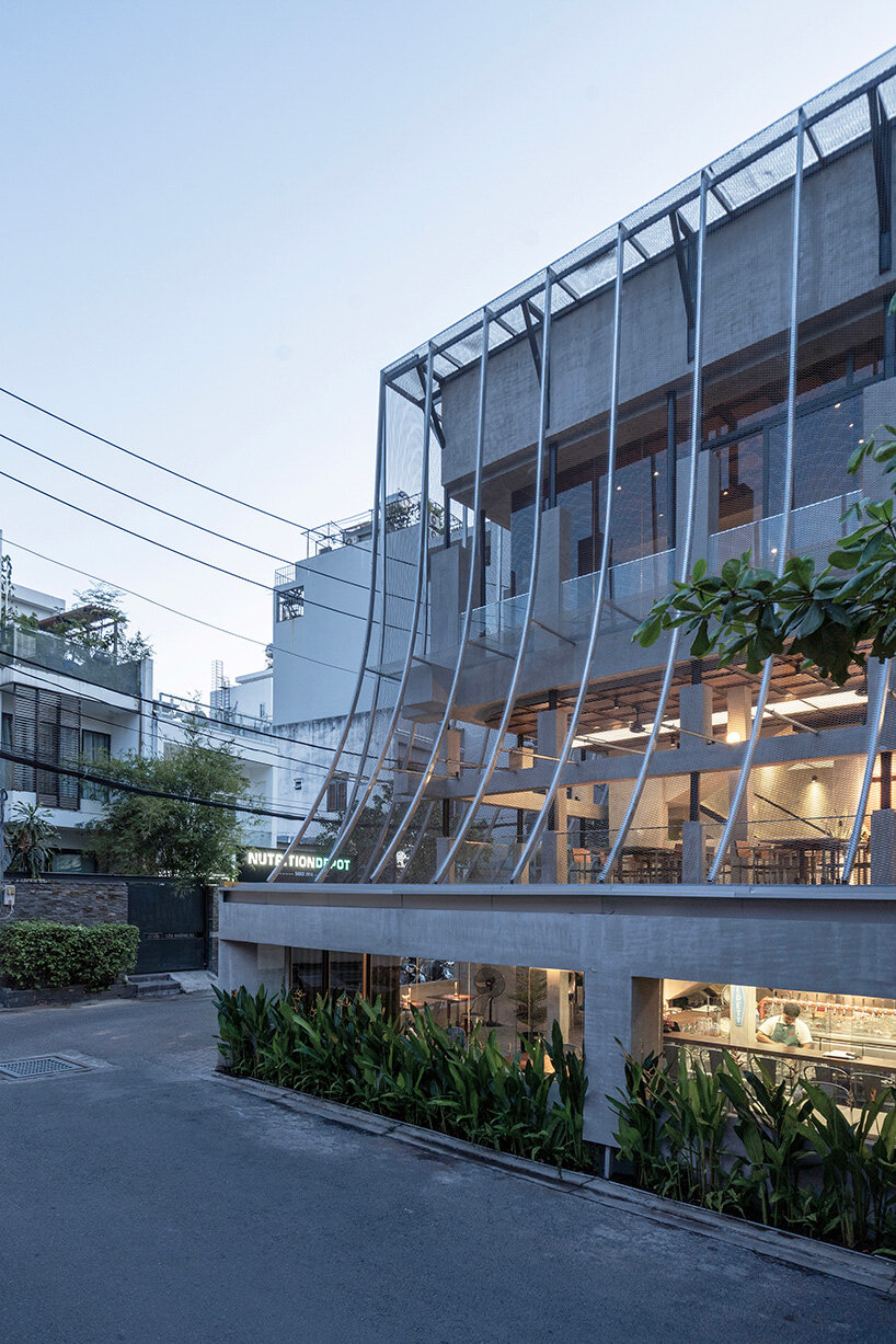 perforated metal veil by KHOA VU transforms old vietnamese villa into breathable restaurant