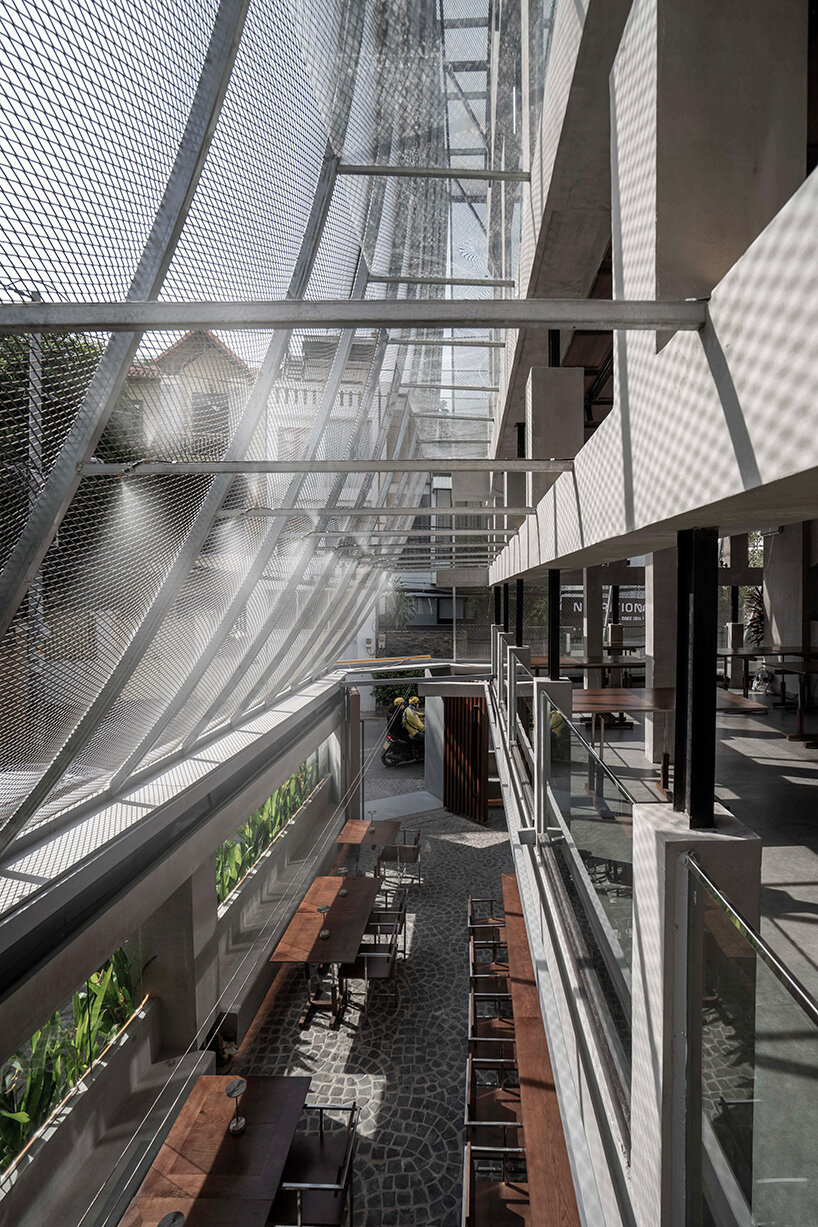 perforated metal veil by KHOA VU transforms old vietnamese villa into breathable restaurant