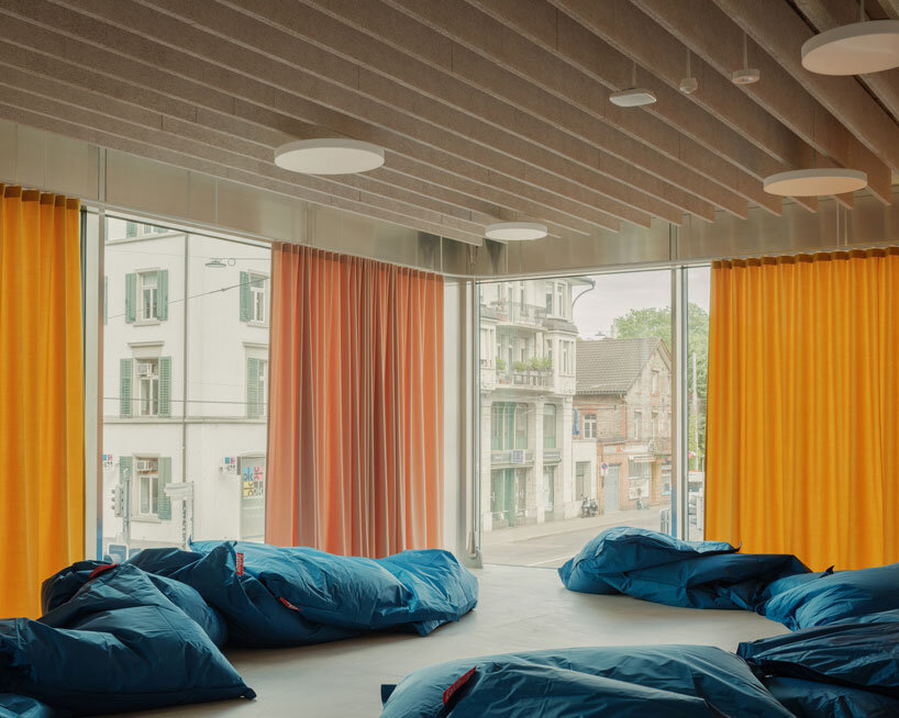 elevated concrete truss frame forms vocational school for construction trades in zurich