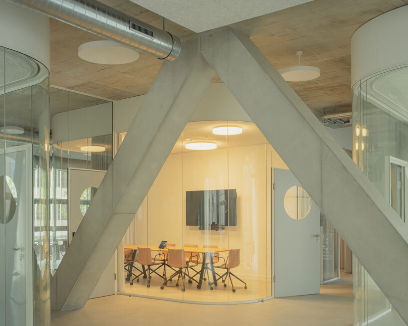 elevated concrete truss frame forms vocational school for construction trades in zurich