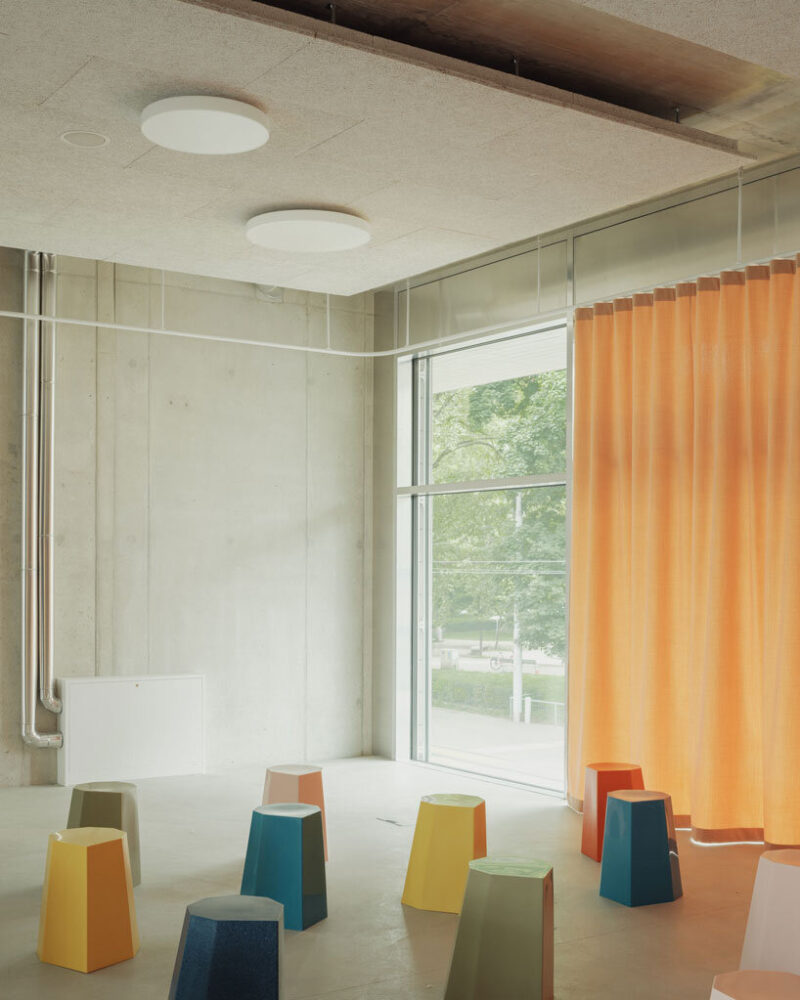 elevated concrete truss frame forms vocational school for construction trades in zurich