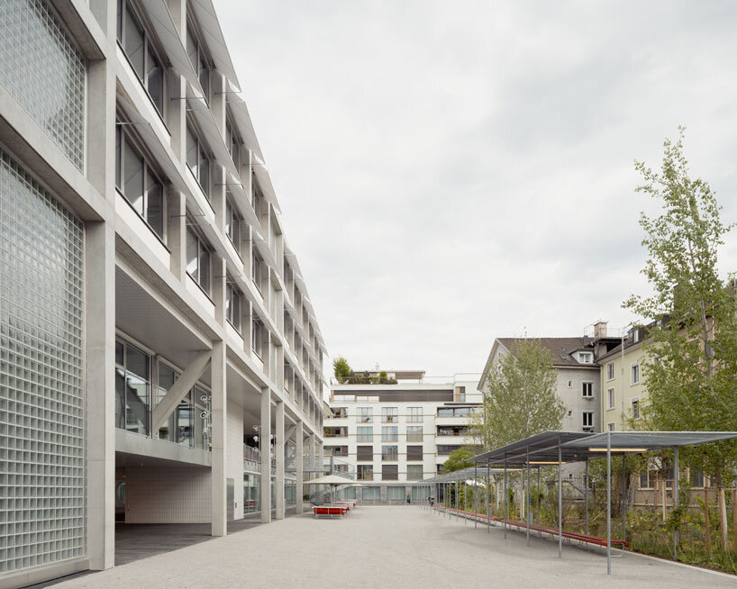 elevated concrete truss frame forms vocational school for construction trades in zurich