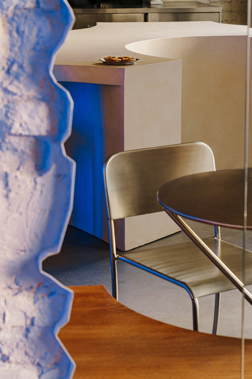 golden ceiling foams above reef-shaped counter in warsaw bakery by znamy się